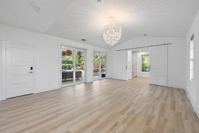189 Shelter Ln, Jupiter Inlet Colony, FL 33469 - unfurnished living room with a barn door, a chandelier, lofted ceiling, and light wood finished floors