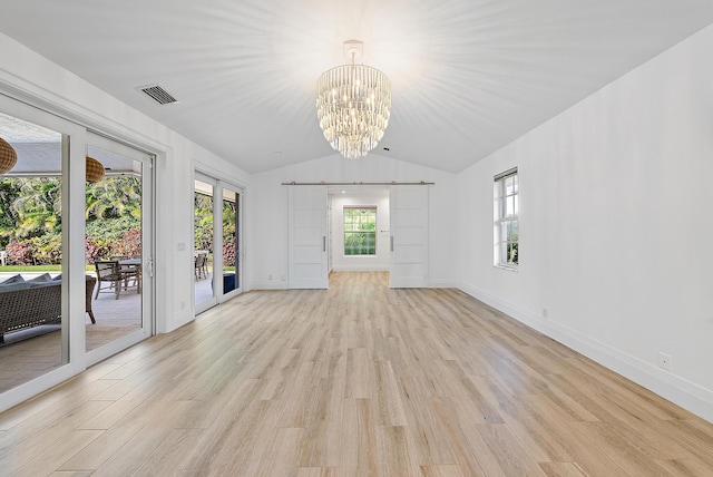 189 Shelter Ln, Jupiter Inlet Colony, FL 33469 - unfurnished room featuring a barn door, light wood-style flooring, a chandelier, and vaulted ceiling