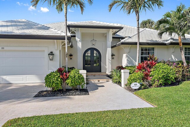 189 Shelter Ln, Jupiter Inlet Colony, FL 33469 - foyer featuring light wood-style flooring and french doors
