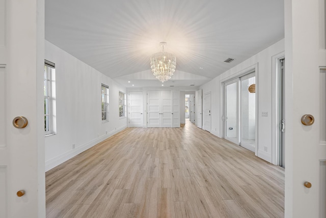 189 Shelter Ln, Jupiter Inlet Colony, FL 33469 - empty room with a chandelier, light wood-style floors, and lofted ceiling