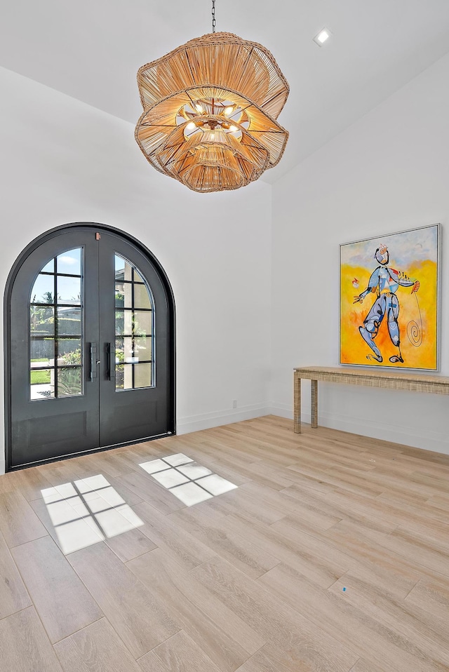 189 Shelter Ln, Jupiter Inlet Colony, FL 33469 - entryway with french doors, wood finished floors, and arched walkways