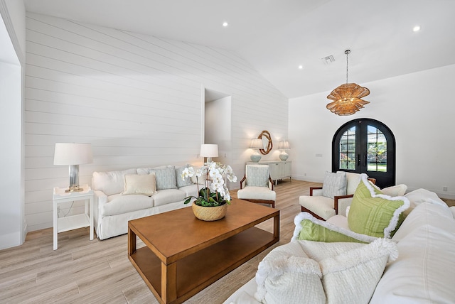189 Shelter Ln, Jupiter Inlet Colony, FL 33469 - living room with light wood finished floors, high vaulted ceiling, french doors, wood walls, and recessed lighting