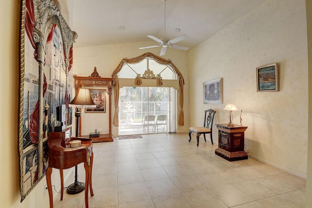 sitting room featuring ceiling fan with notable chandelier, a textured ceiling, light tile patterned floors, and high vaulted ceiling