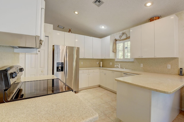 kitchen featuring white cabinets, appliances with stainless steel finishes, sink, kitchen peninsula, and light tile patterned flooring