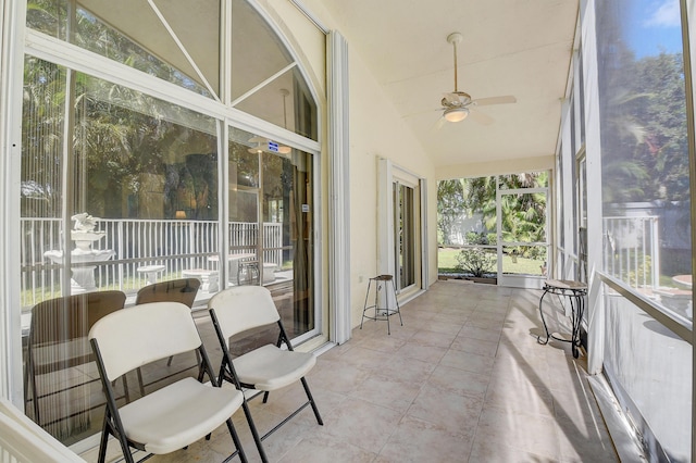 sunroom / solarium featuring lofted ceiling and ceiling fan