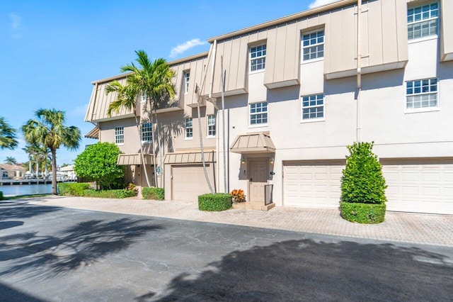 view of property with a garage and a water view