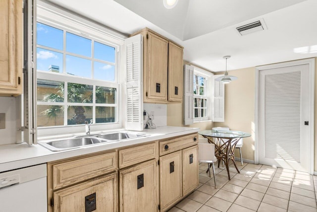 kitchen with dishwasher, sink, pendant lighting, and light brown cabinets