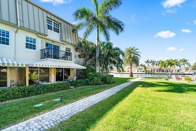 view of home's community featuring a yard and a water view