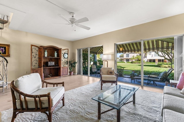 living room featuring light hardwood / wood-style floors and ceiling fan