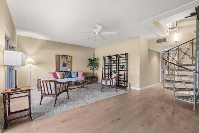 living room featuring hardwood / wood-style flooring and ceiling fan