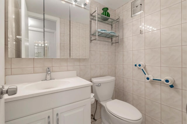 bathroom featuring tile walls, vanity, backsplash, and toilet