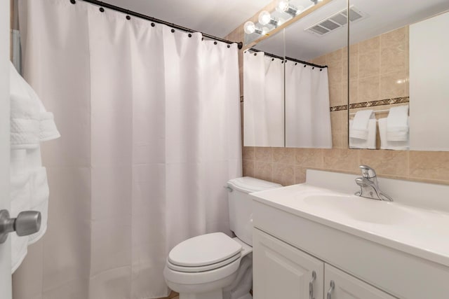 bathroom featuring vanity, tile walls, a shower with shower curtain, and toilet