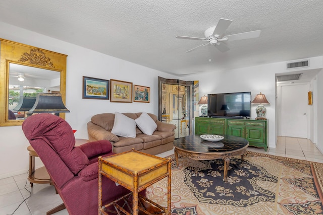 tiled living room with ceiling fan and a textured ceiling