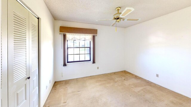 479 SE Verada Ave, Port Saint Lucie, FL 34983 - unfurnished bedroom with light carpet, ceiling fan, a textured ceiling, and a closet
