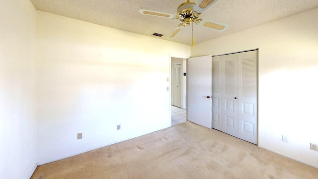 479 SE Verada Ave, Port Saint Lucie, FL 34983 - unfurnished bedroom with visible vents, ceiling fan, light carpet, a closet, and a textured ceiling