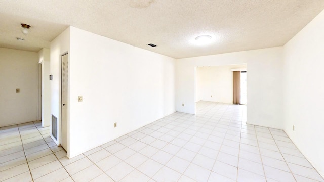 479 SE Verada Ave, Port Saint Lucie, FL 34983 - empty room featuring light tile patterned floors, visible vents, and a textured ceiling