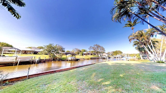 479 SE Verada Ave, Port Saint Lucie, FL 34983 - view of yard with a dock and a water view