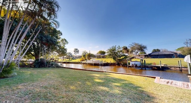 479 SE Verada Ave, Port Saint Lucie, FL 34983 - view of yard featuring a boat dock and a water view