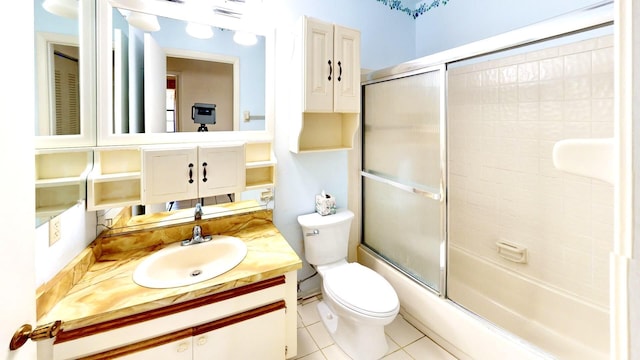 479 SE Verada Ave, Port Saint Lucie, FL 34983 - bathroom with tile patterned floors, vanity, toilet, and bath / shower combo with glass door