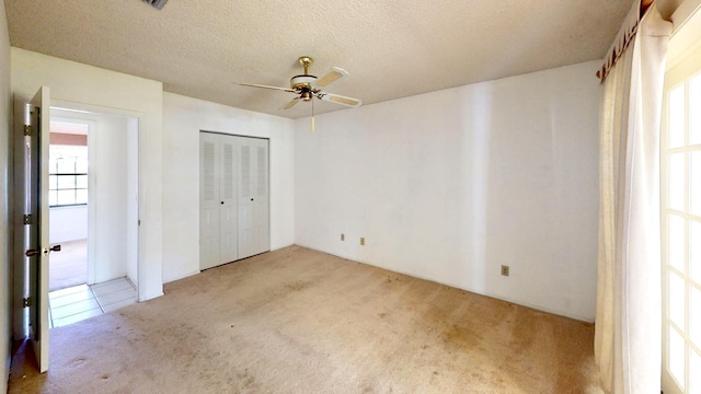 479 SE Verada Ave, Port Saint Lucie, FL 34983 - unfurnished bedroom with a closet, carpet flooring, a textured ceiling, and a ceiling fan