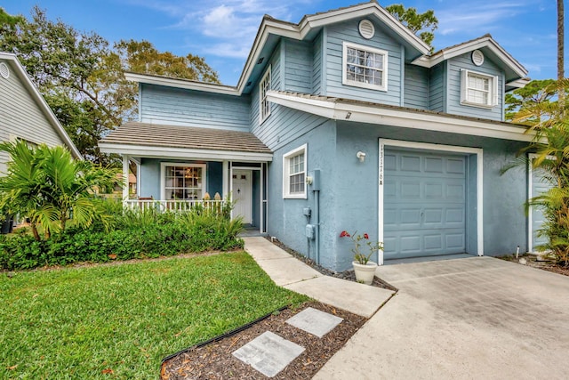 front facade with a front lawn, a garage, and a porch