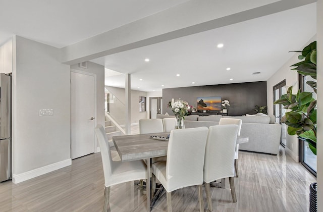 dining space with light wood-type flooring