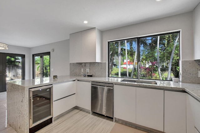 kitchen with white cabinetry and beverage cooler