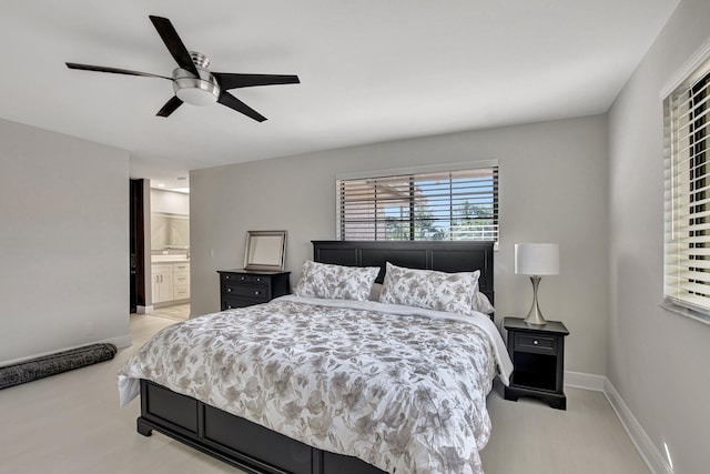 bedroom featuring ceiling fan and ensuite bathroom