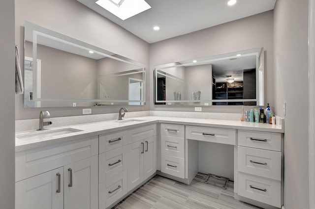 bathroom with vanity and a skylight