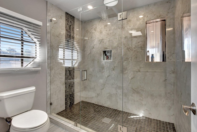 bathroom with an enclosed shower and toilet