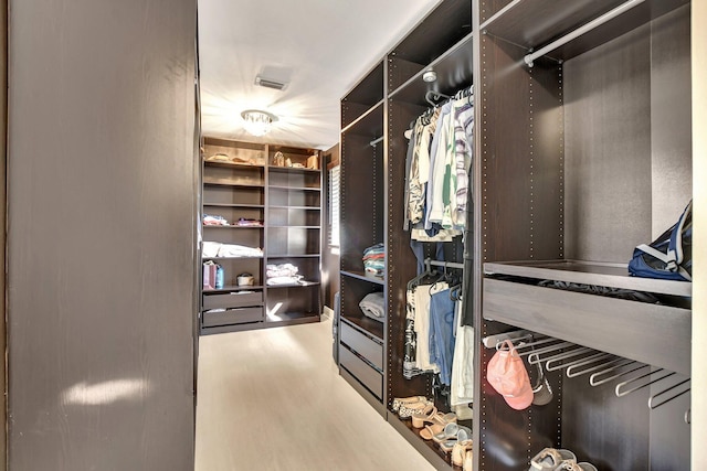 walk in closet featuring hardwood / wood-style floors