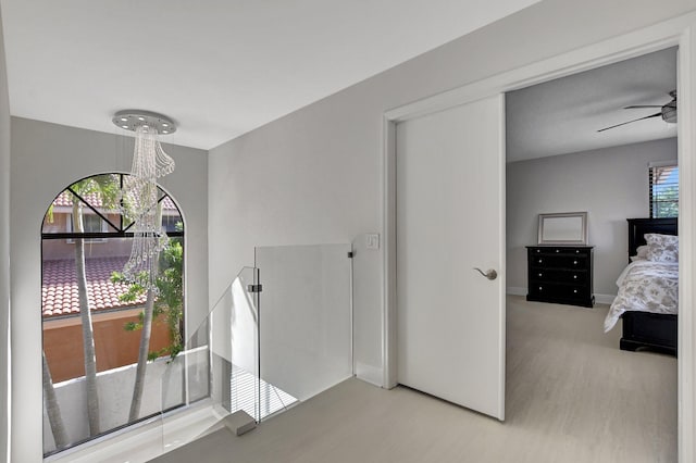 interior space featuring ceiling fan with notable chandelier