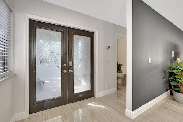 interior space with lofted ceiling and french doors