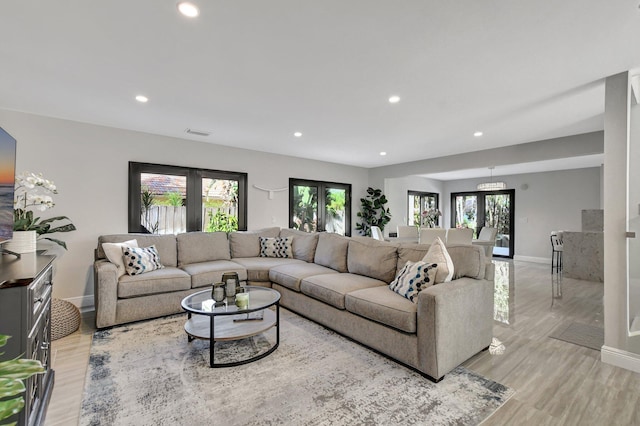 living room featuring light hardwood / wood-style floors and french doors