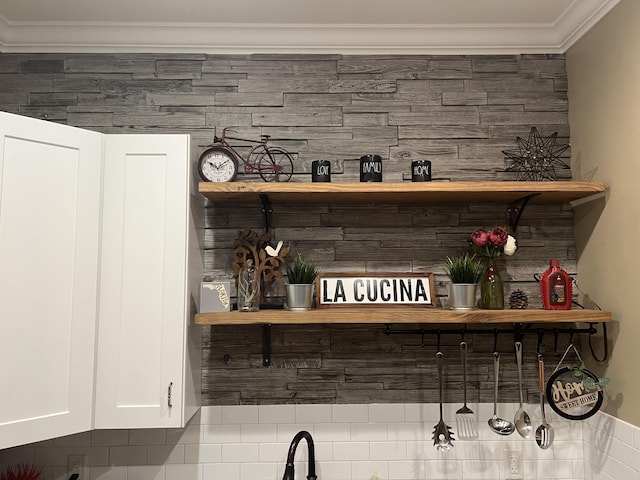 bar with crown molding and white cabinets