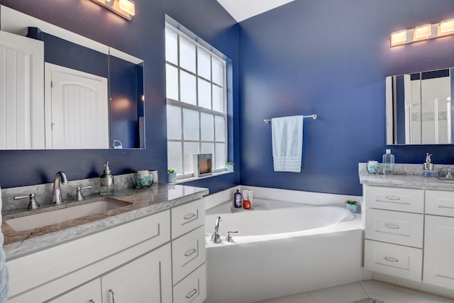 bathroom featuring vanity, a tub, and tile patterned floors