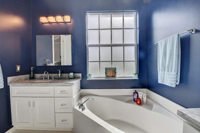 bathroom with vanity and a bath