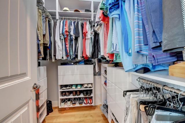 spacious closet with light hardwood / wood-style flooring