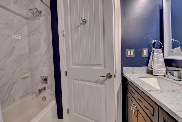 bathroom with vanity and tiled shower / bath combo