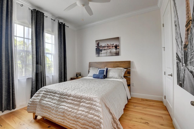 bedroom with ceiling fan, ornamental molding, and light hardwood / wood-style flooring