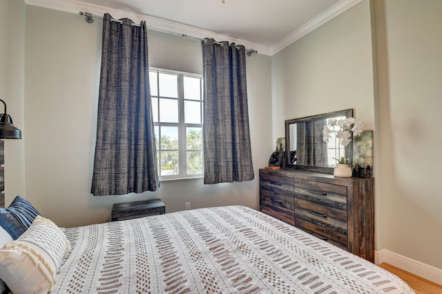 bedroom featuring crown molding and hardwood / wood-style floors