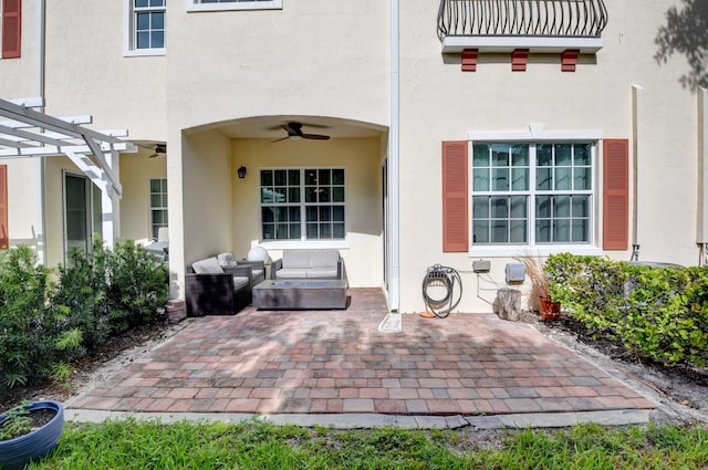 entrance to property with a pergola, an outdoor hangout area, and a patio area