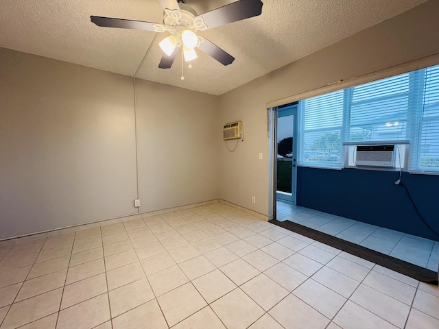 tiled empty room featuring a textured ceiling, ceiling fan, a wall mounted AC, and cooling unit