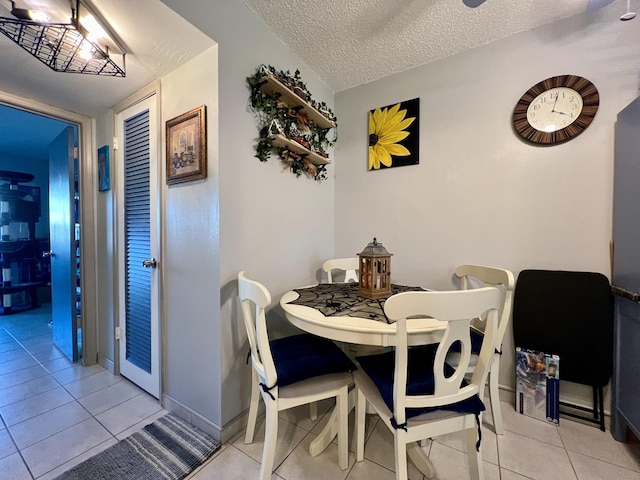 tiled dining room with a textured ceiling