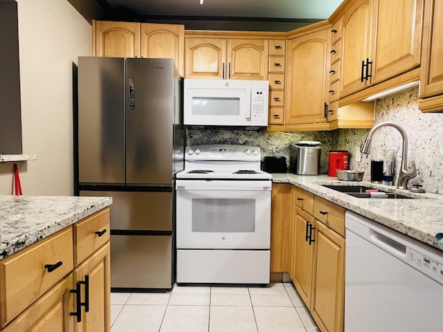 kitchen with white appliances, decorative backsplash, sink, light tile patterned flooring, and light stone counters