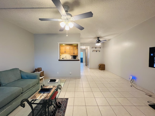 tiled living room featuring ceiling fan and a textured ceiling