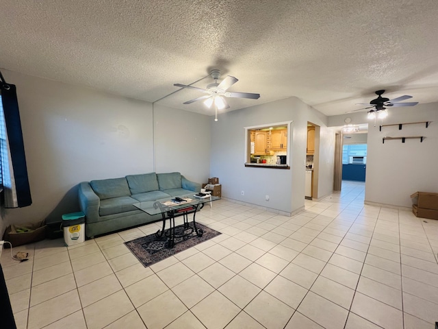 tiled living room featuring ceiling fan and a textured ceiling