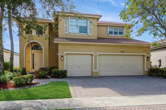 mediterranean / spanish-style home with a garage