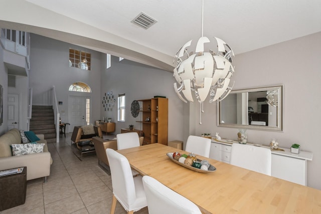 tiled dining area featuring a chandelier