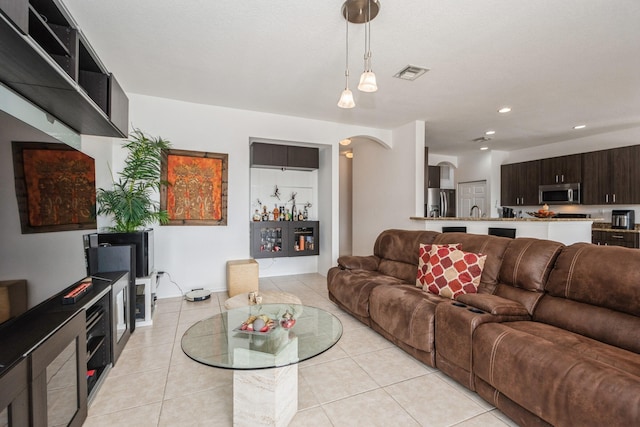 living room with light tile patterned floors and sink